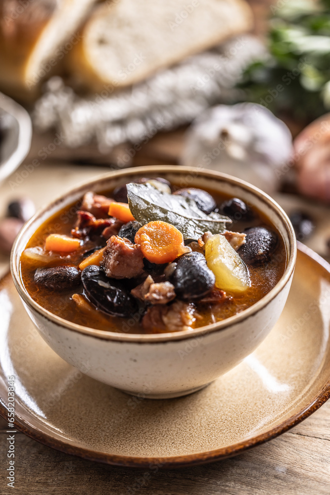 Traditional bean soup made from big beans, smoked neck, potatoes, and carrots Traditional bean soup made from big beans, smoked neck, potatoes, and carrots