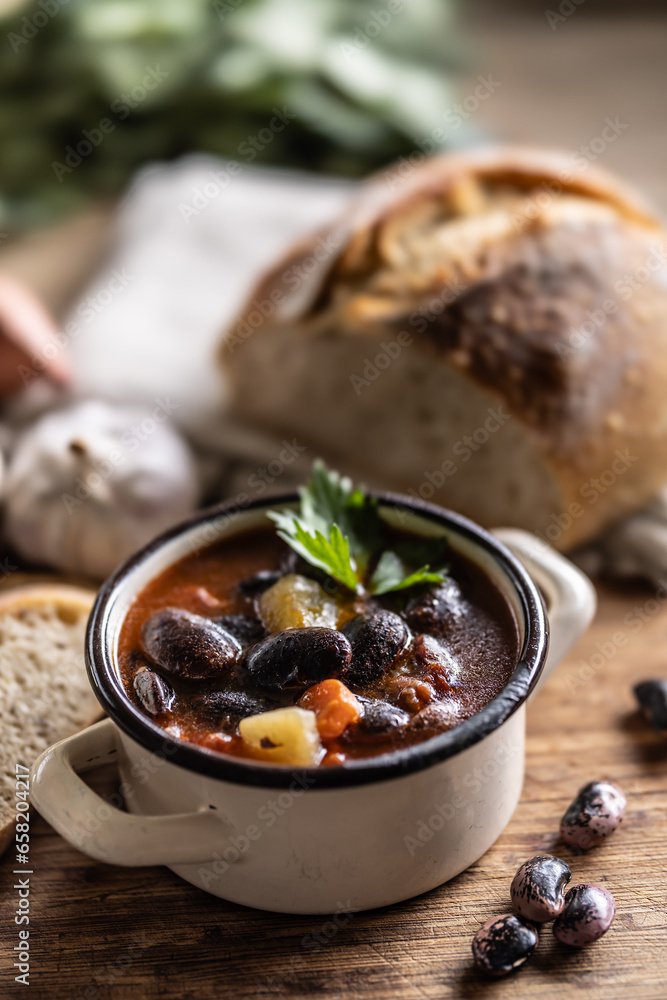 Traditional bean soup made from big beans, smoked neck, potatoes, and carrots Traditional bean soup made from big beans, smoked neck, potatoes, and carrots