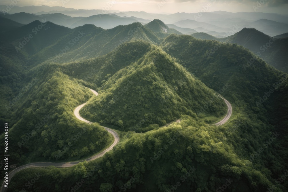 A scenic aerial view of a winding mountain road surroundings