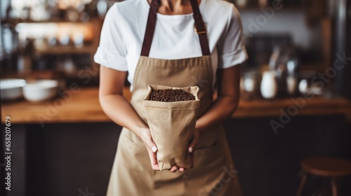 Small cafe owner or barista woman holding coffee beans in jute bag photo