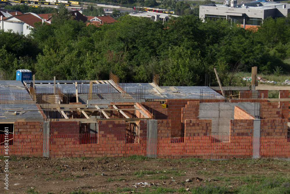 A building under construction with trees in the background A building under construction with trees in the background