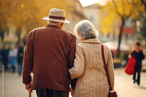 Elderly couple walking in the city. Back view of senior man and woman walking in the city.