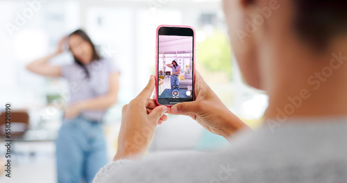 Phone, woman and influencer recording video for social media, vlog or online post dancing at home. Hands, cellphone and female content creator live streaming and moving to music in living room.