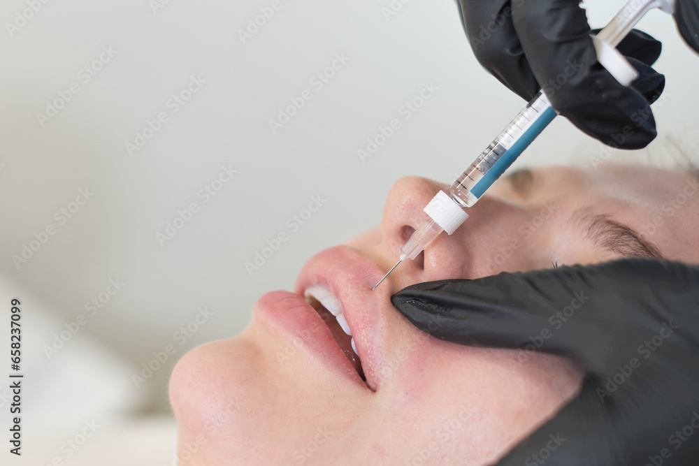 Woman undergoes lip enhancement procedure. Pursuit of fullness; treading the line of natural vs artificial.