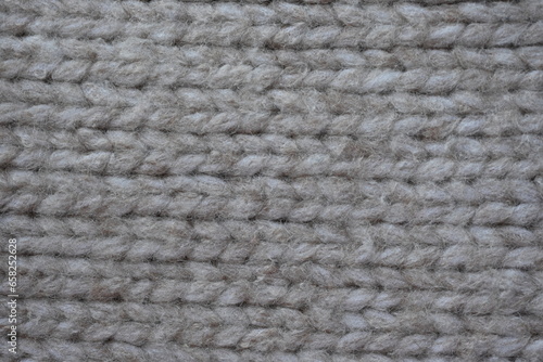 Symmetrical plain beige hand knitted woollen fabric with textured patterns, Hand knitted beige wool fabric with a pattern texture