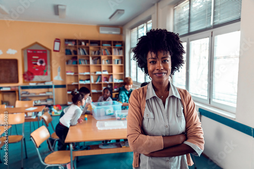 Portrait of a young African American elementary school teacher at her classroom photo