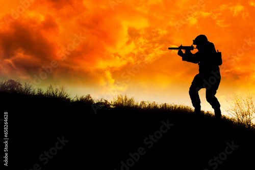 soldier with gun on a hill in silhouette