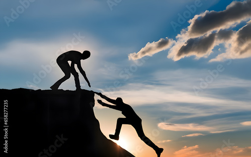 Silhouettes of two people helping each other reach the mountain top. Help and team work concept. photo
