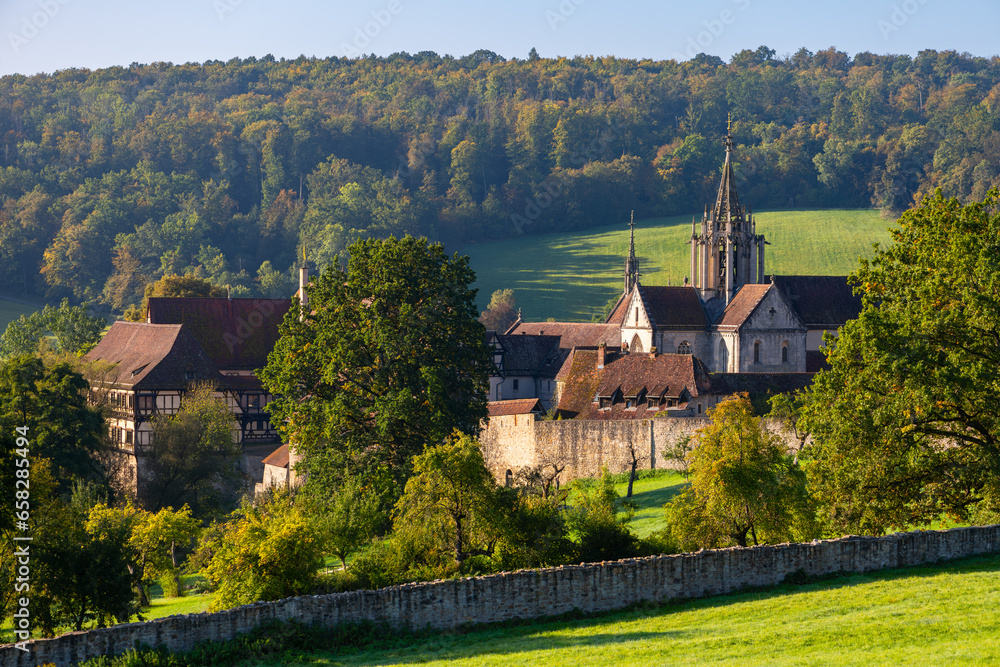 “Kloster Bebenhausen“ monastery and castle near Tübingen in southern Germany on a sunny late summer morning. Medieval landmark monument and tourist attraction with church tower and truss houses.