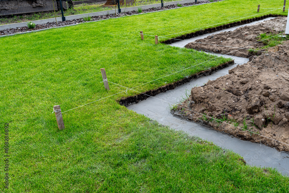 Foundation footings poured in a ditch in the yard, building a terrace in the backyard. Foundation footings poured in a ditch in the yard, building a terrace in the backyard.
