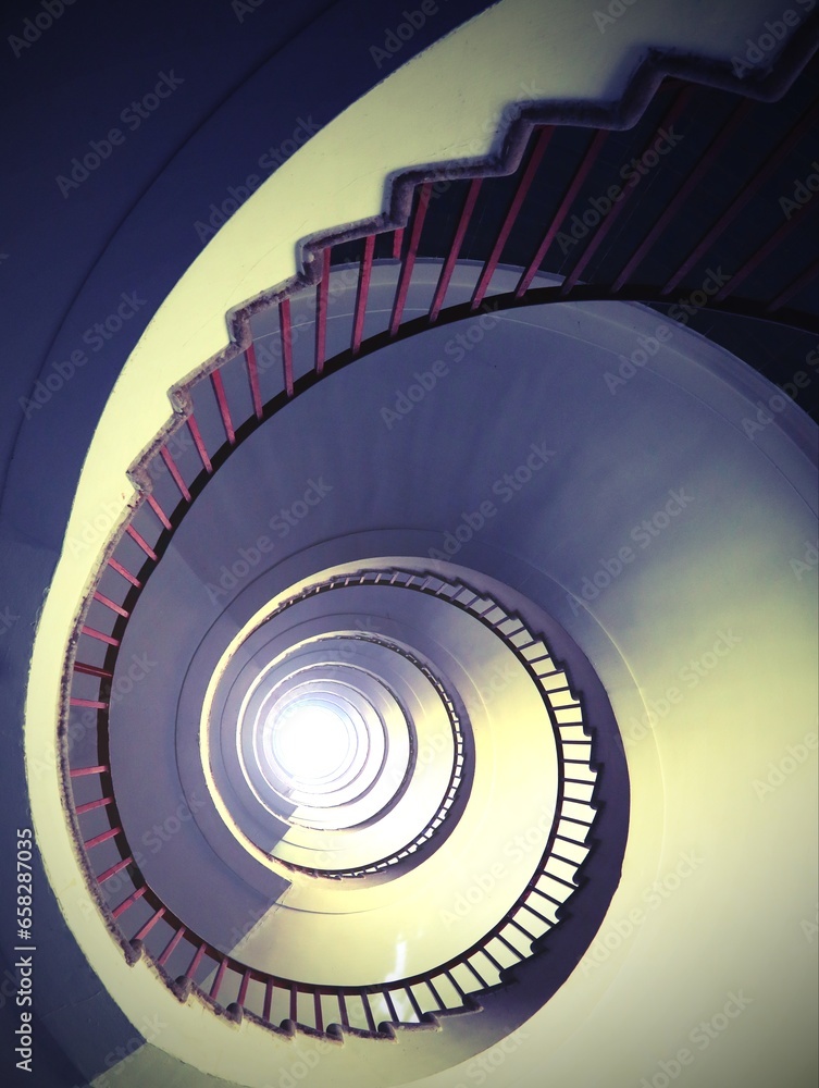 Fototapeta premium almost hypnotic effect of a spiral staircase that rises upwards with an antique effect