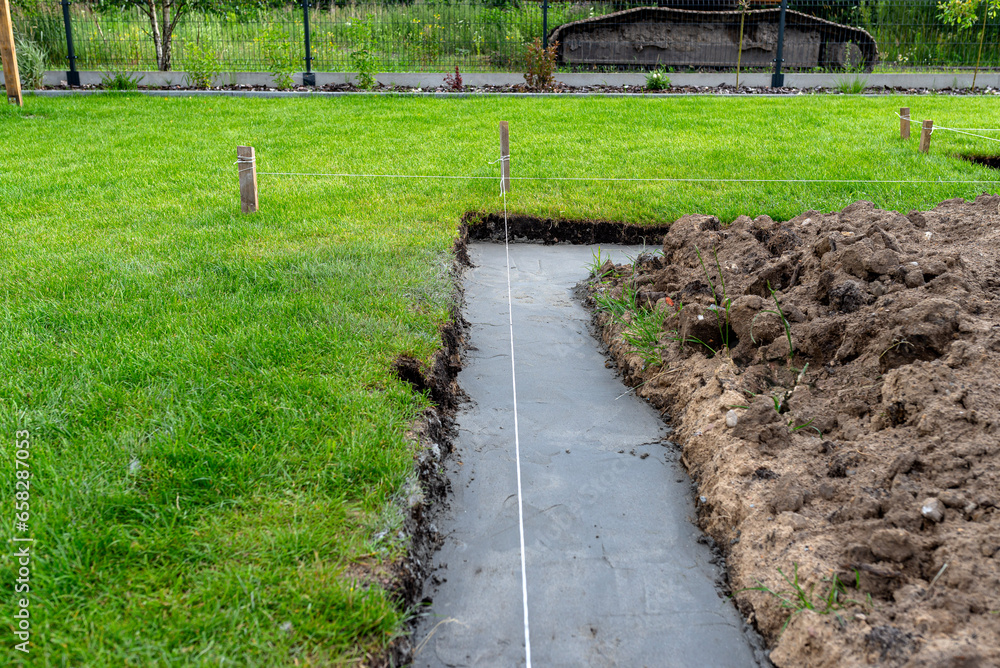 Obraz premium Foundation footings poured in a ditch in the yard, building a terrace in the backyard.