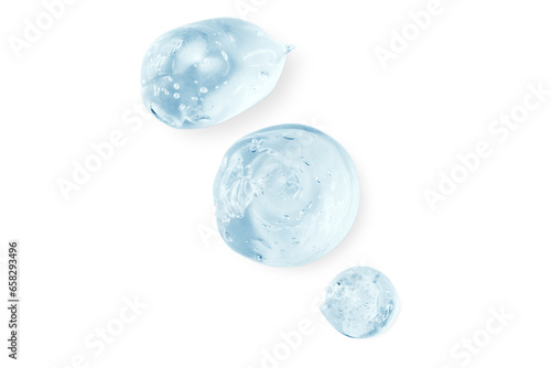 Composition of smears and drops or drops of a transparent blue gel, serum. On an empty transparent background.