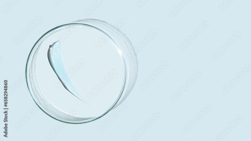 Petri dish and drops and ointments of transparent gel or serum on a blue background. Banner with empty space for advertising. Petri dish and drops and ointments of transparent gel or serum on a blue background. Banner with empty space for advertising.