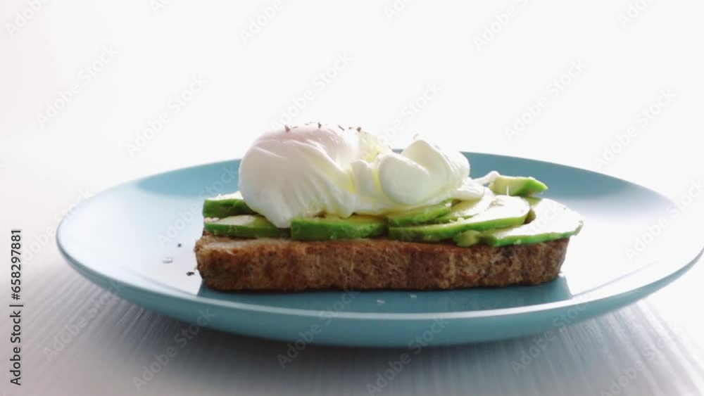 Egg Benedict,classic poached egg on toasted bread with avocado and juicy yolk Egg Benedict,classic poached egg on toasted bread with avocado and juicy yolk