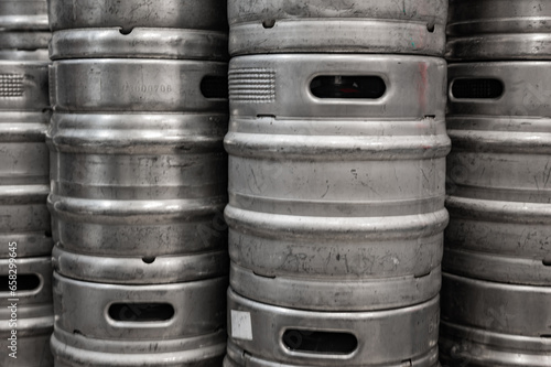 Range of stacked beer casks of kegs in brewery.