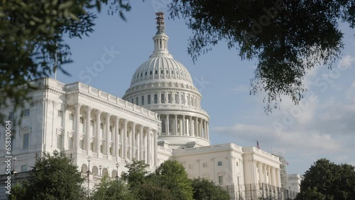 Establishing exterior shot during the day time and view of white capital building on United States of American mall with congress senators and house of representatives chambers inside photo