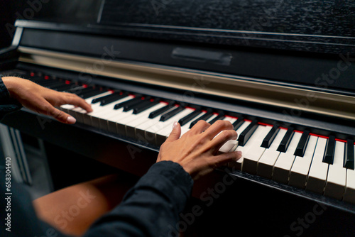 Close-up of a woman s hands in silver rings playing beautiful lyrical melody on the piano keys 