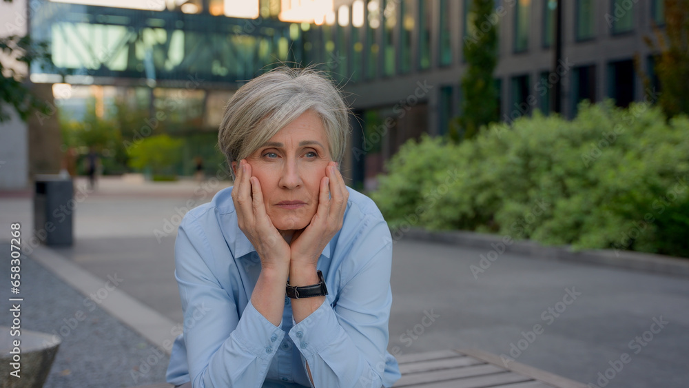 Upset pensive sad worried old woman Caucasian senior businesswoman thinking grief thoughts mature lady contemplate outdoors worry career failure business problem stress tired think solution in city