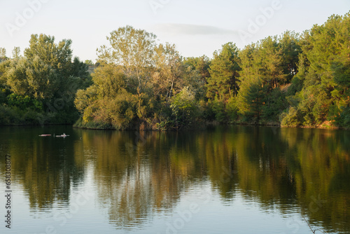 Fototapeta Naklejka Na Ścianę i Meble -  Beautiful autumn scenery. Scenic evening view of Lake and autumn forest. Colorful autumn scene of Greece, Europe. Beauty of nature concept background
