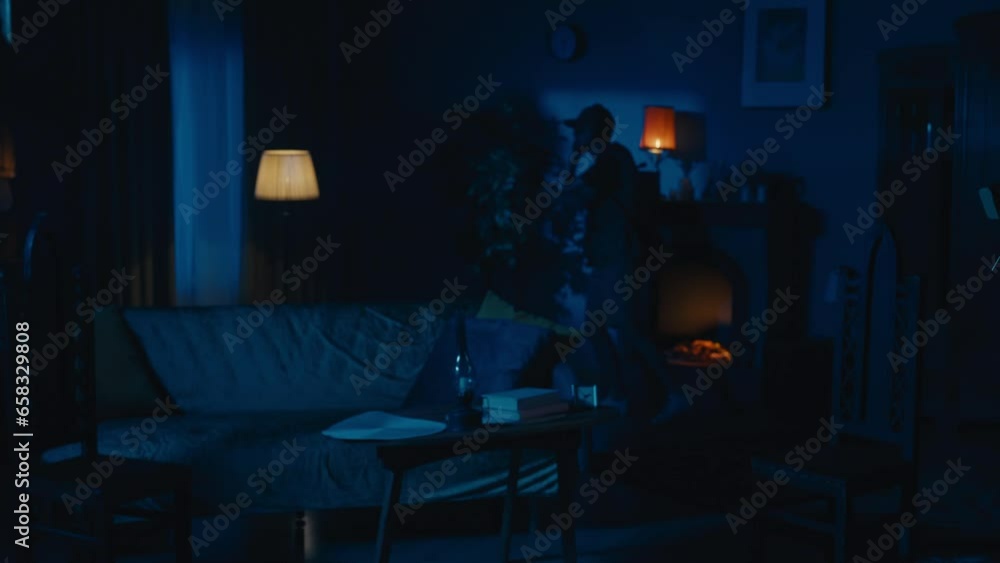 Zoom in video capturing two ghost hunters entering a dark room in search for an entity that's making the lights flash, filming the surroundings on camera. Zoom in video capturing two ghost hunters entering a dark room in search for an entity that's making the lights flash, filming the surroundings on camera.