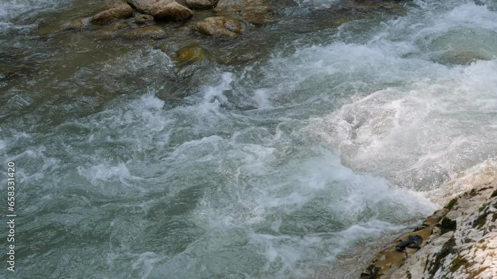 A fast mountain river with rapids in the gorge. Beautiful views of the mountain river. Active recreation in the mountains. A fast mountain river with rapids in the gorge. Beautiful views of the mountain river. Active recreation in the mountains.