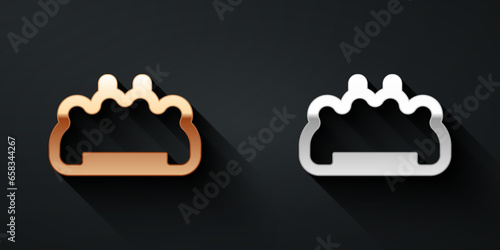 Gold and silver Brass knuckles icon isolated on black background. Long shadow style. Vector