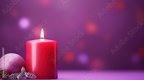  a red candle with a christmas ornament next to it. generative ai