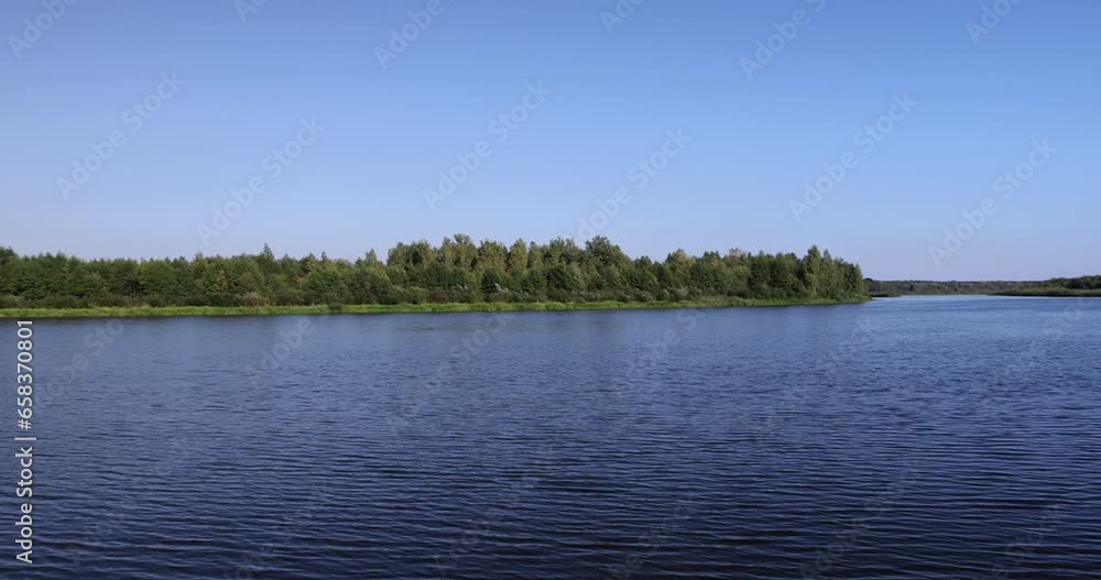 River in sunny weather with blue sky, waves on a wide river in clear sunny weather River in sunny weather with blue sky, waves on a wide river in clear sunny weather