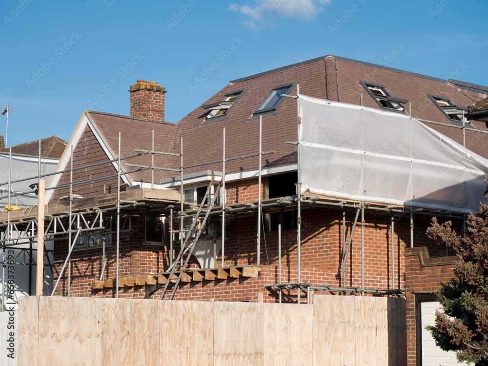 Europe, UK, England, Surrey, scaffolding on house roof renovation