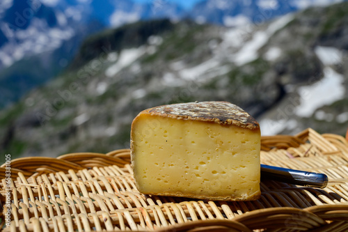 Cheese collection, Tomme de Savoie cheese from Savoy region in French Alps, mild cow's milk cheese with beige interior and thick brownish-grey rind close up photo