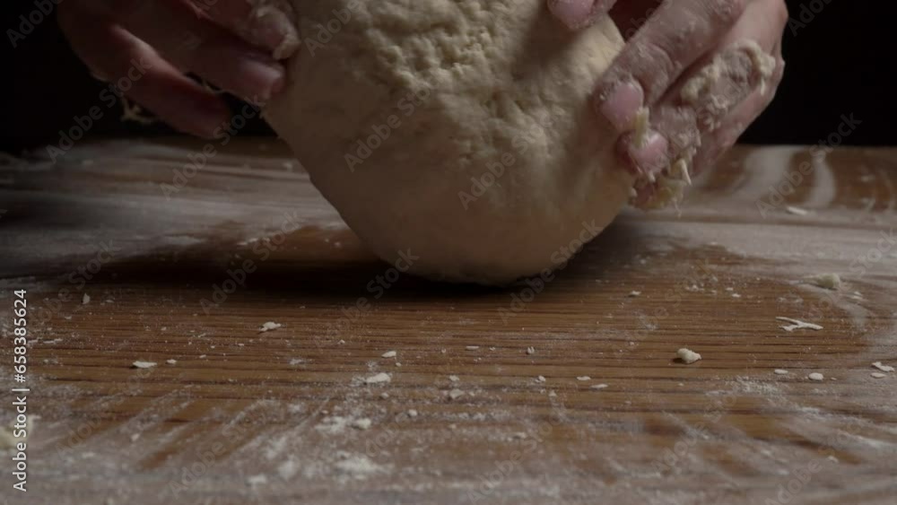 A girl kneads dough on a table with her bare hands A girl kneads dough on a table with her bare hands