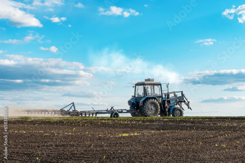tractor plows the large soil field. Panorama photo rows of soil before planting. Furrows row pattern in a plowed field prepared for planting crops in spring. Scenic view