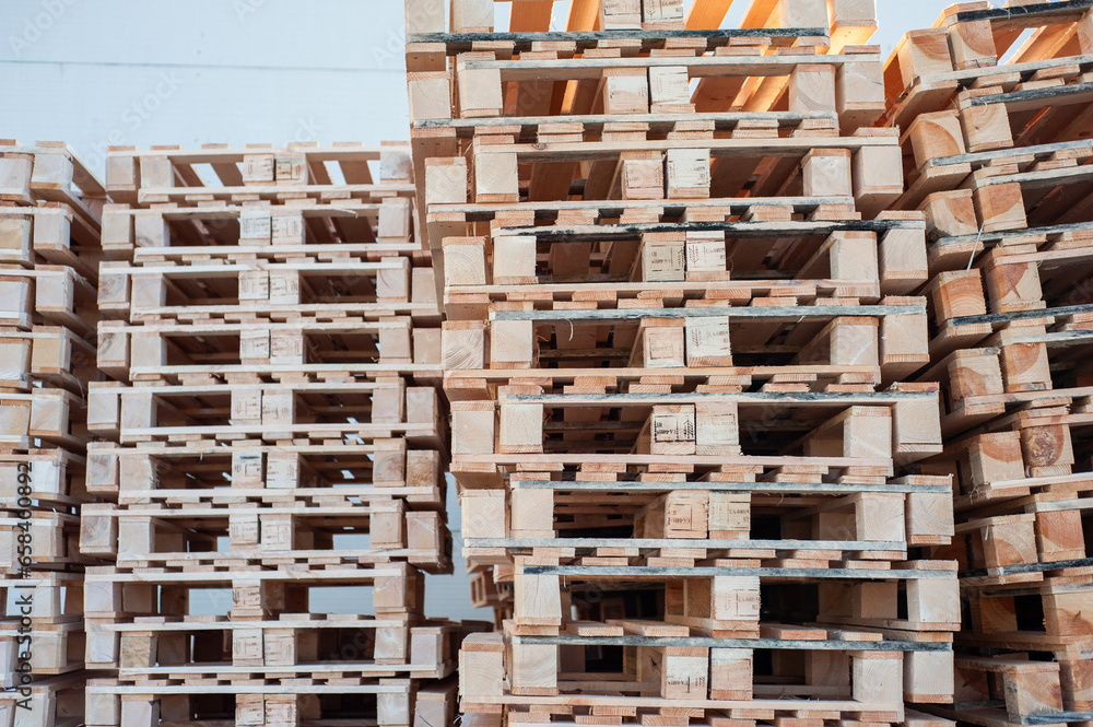 stacked pallets in warehouse. Wood industry