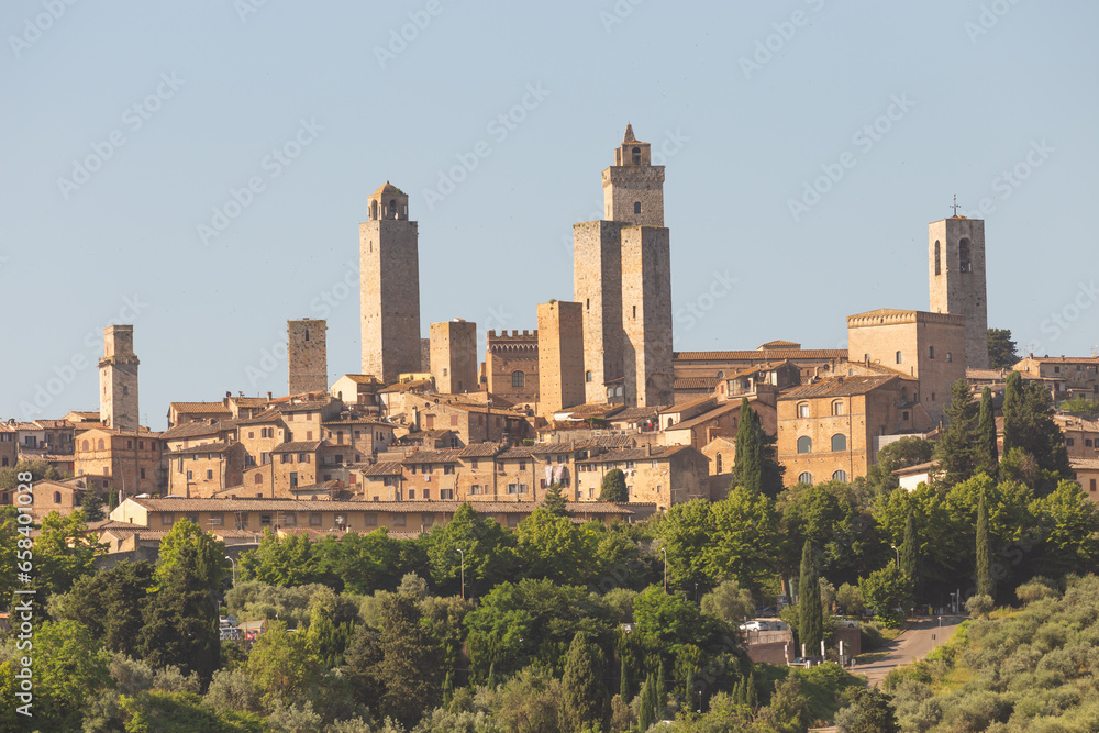 San Gimignano village, Italy: green countryside, blue sky, hill panorama with town and towers