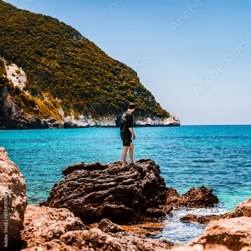man on a rock on a tropical beach