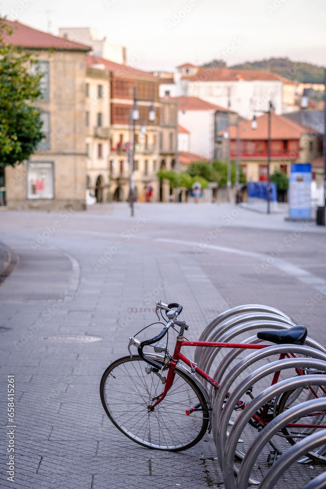 Red bicycle parked in a special parking area enabled for bicycles in a street in Pontevedra (Spain)