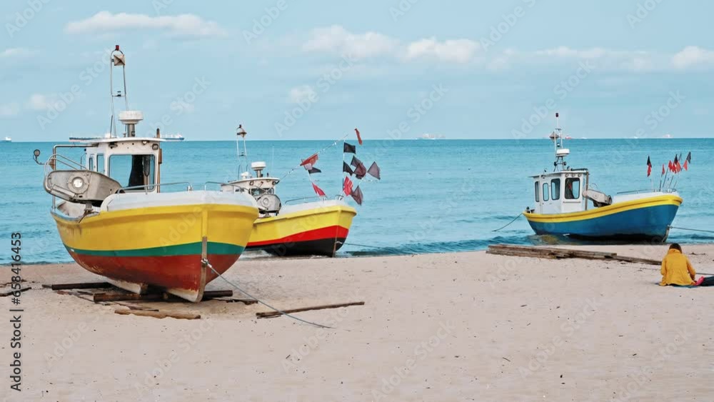 Undecked Handliner Fishing Vessel with Net Flags and Rusty Hooks Purse Sein Equipment Parked on Beach Sand at Seashore on Calm Day Undecked Handliner Fishing Vessel with Net Flags and Rusty Hooks Purse Sein Equipment Parked on Beach Sand at Seashore on Calm Day