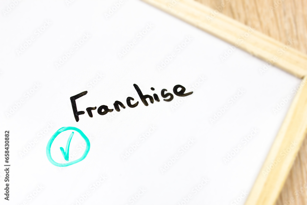 FRANCHISE text, word written with a marker. Franchise, financial business concept. FRANCHISE text, word written with a marker. Franchise, financial business concept.