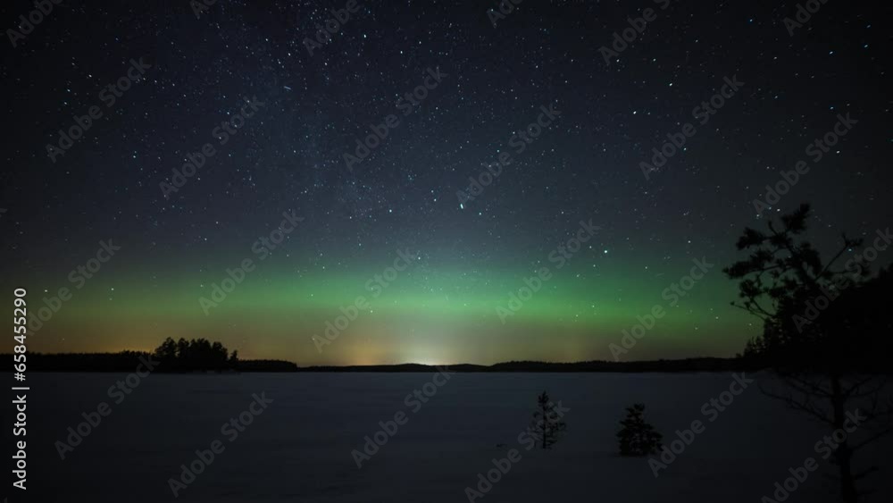 Time lapse of aurora borealis over a frozen lake in forests of Pirkanmaa, Finland Time lapse of aurora borealis over a frozen lake in forests of Pirkanmaa, Finland