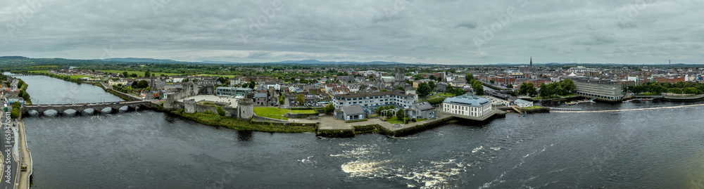 Aerial view of Limerick city on the banks of the Shannon river with the Thomond bridge, King John's castle, King's island, abbey