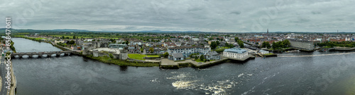 Aerial view of Limerick city on the banks of the Shannon river with the Thomond bridge, King John's castle, King's island, abbey