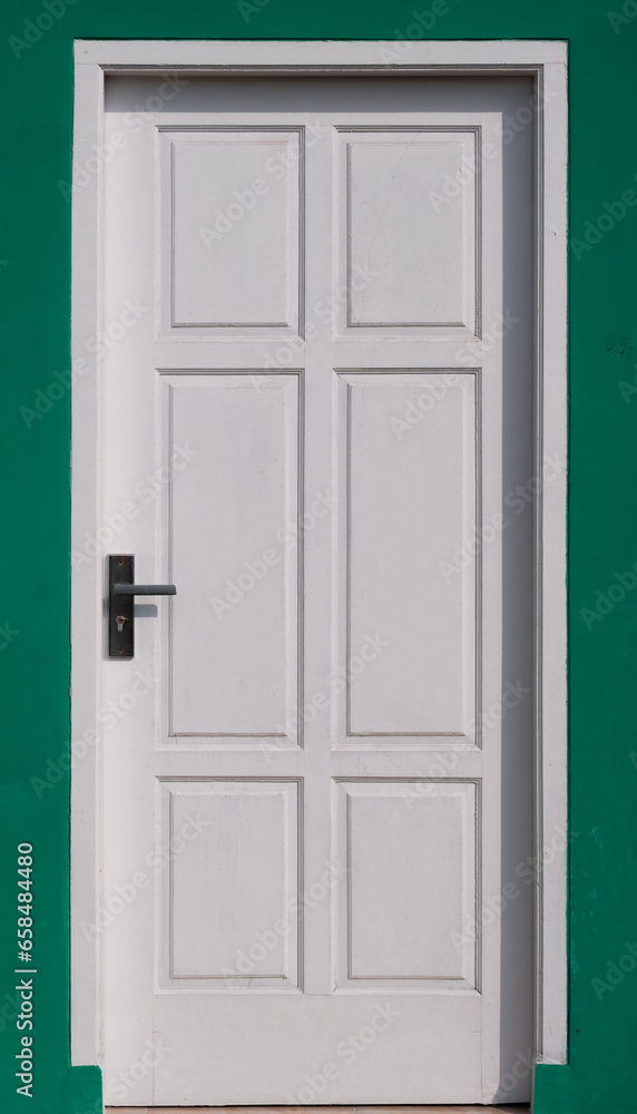 Front white door in green wall background Front white door in green wall background