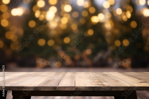 Empty wooden table for displaying product with blurred Christmas tree and beautiful light bokeh, Christmas background.