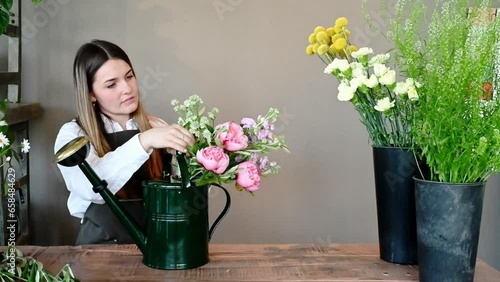 Female florist arranging flowers in shop
