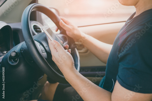 A man using smartphone in car
