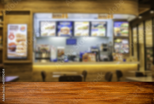 Wood table blank screen with restaurants in the mall
