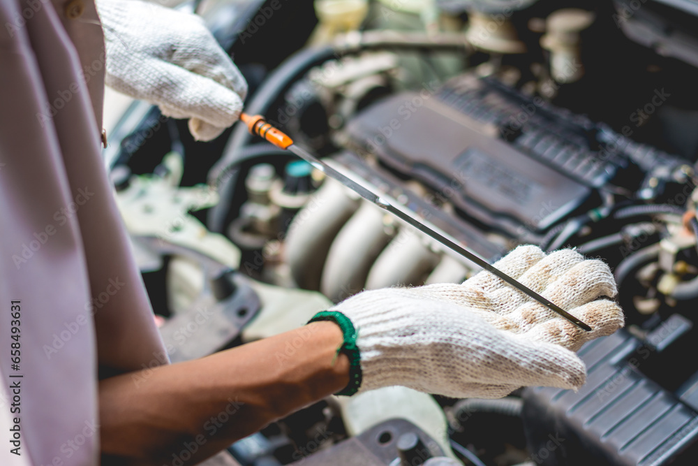 Fototapeta premium Repairman Checking Engine Oil Level .Repair Service