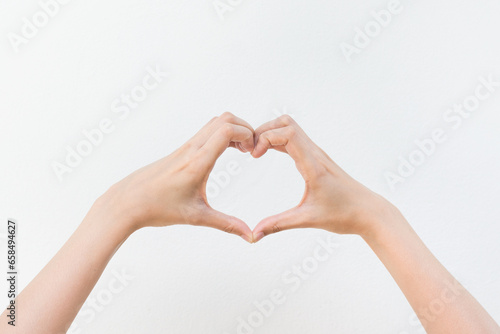 Women showing finger a heart symbol on white background