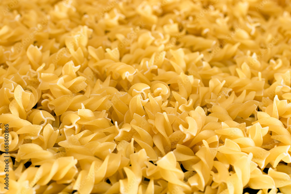 Uncooed Fusilli Pasta - Background. Texture of Bright Golden Dry Macaroni Uncooed Fusilli Pasta - Background. Texture of Bright Golden Dry Macaroni